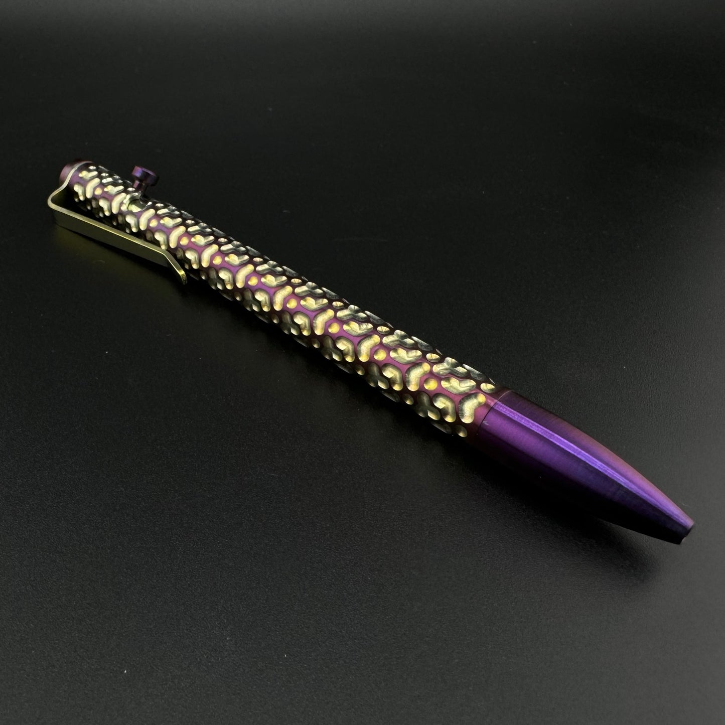 A purple pen featuring elegant gold accents, showcasing a sophisticated and stylish design.